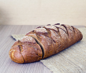 Fresh Tasty Bread on Woody Background