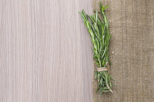Rosemary Bound on a Wooden Board Background. Lots of copy space.