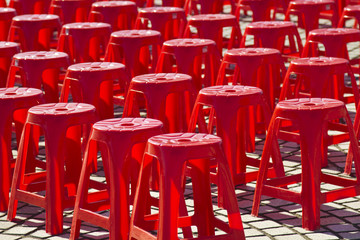Empty red plastic chairs