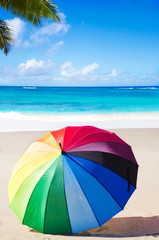 Summer background with rainbow umbrella