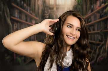Obraz premium Young beautiful woman enjoying the music at home