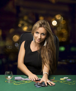 blond girl in a casino playing poker, bokeh