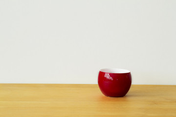 Red cup on a brown wood table
