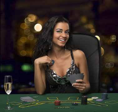 brunette girl in the casino playing poker, bokeh