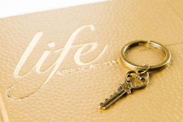 A golden key on bible