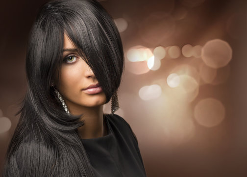 portrait of a young beautiful girl with shiny hair on the backgr