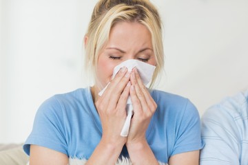 Closeup of a young woman suffering from cold
