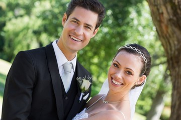 Happy young bride and groom in garden