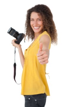 Portrait of a female photographer gesturing thumbs up