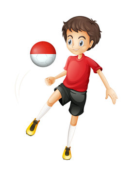 A boy using the ball with the Monaco flag