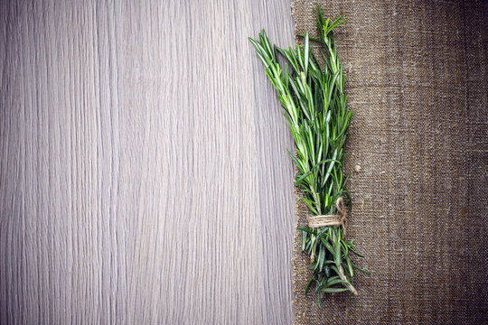 Rosemary Bound on a Wooden Board Background. Lots of copy space.