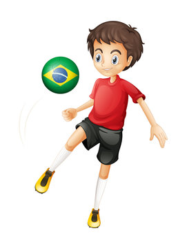 A boy using the ball with the flag of Brazil
