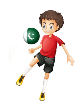 A boy using the ball with the Pakistan flag