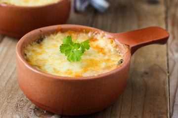 Mushrooms baked with cheese crust in ceramic pot