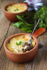 Roasted mushrooms in a pot with cheese