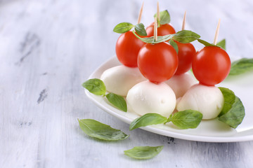 Tasty mozzarella cheese with basil and tomatoes