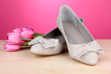Plakat Beautiful grey female shoes and flowers on pink background