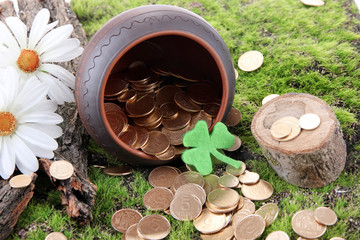Golden coins falling out from pot, on bright background