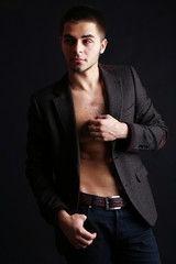 Handsome young man on dark background