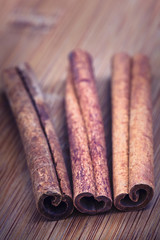 Cinnamon sticks on a wooden surface