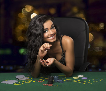 brunette girl in the casino playing poker