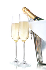 Glasses of champagne and bottle in pail, isolated on white