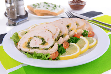 Delicious chicken roll on plate on table close-up