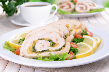 Delicious chicken roll on plate on table close-up