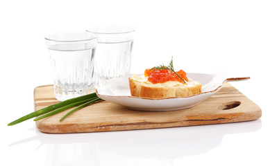 Sandwich with caviar and vodka on wooden board isolated on