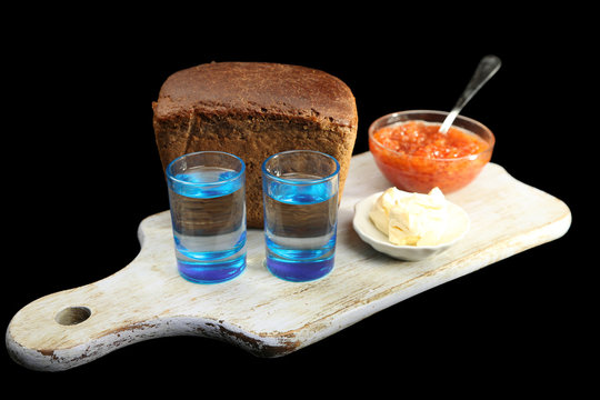 Composition with glasses of vodka, red caviar, fresh bread