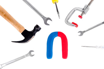 Horseshoe magnet with tools isolated on white