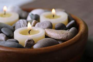 Composition with spa stones, candles on bamboo mat background