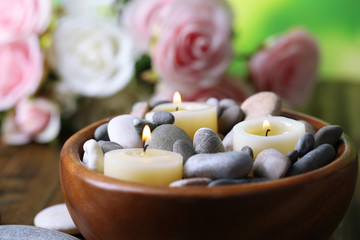 Composition with spa stones, candles  and flowers