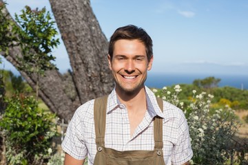 Smiling man against the blue sky on a sunny day