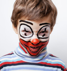 little cute boy with facepaint like clown, pantomimic expression
