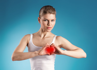 Attractive female forming heart shape over blue background