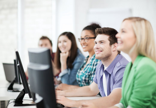 students with computers studying at school