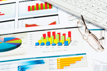 glasses, business papers with charts