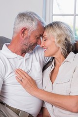 Relaxed mature couple with head to head and eyes closed