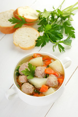 Meatball soup in white bowl