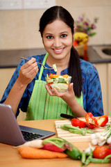 Young Indian woman eating salad