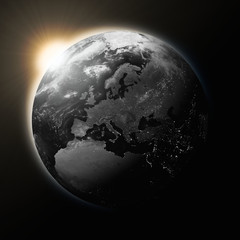 Obraz na płótnie Canvas Sun over Europe on dark planet Earth