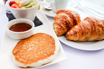 Breakfast with coffee and croissants