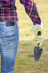 Woman with trowel in the garden