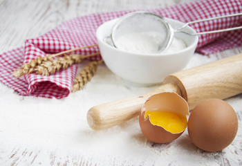 Flour and eggs on a wooden board