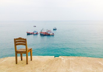 A wooden chair at the top of sea view