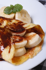 pancake with banana vertical on the table. Macro