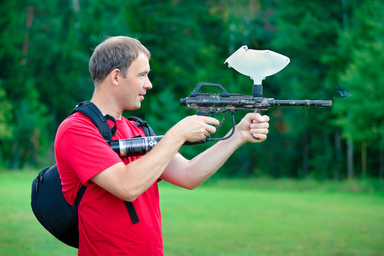 Paintball shooter aiming the gun