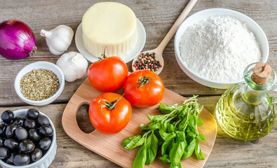 Ingredients for pizza on the wooden background
