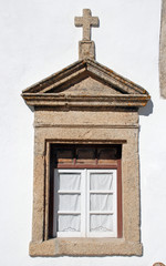 old window in stone rural church, Portugal.